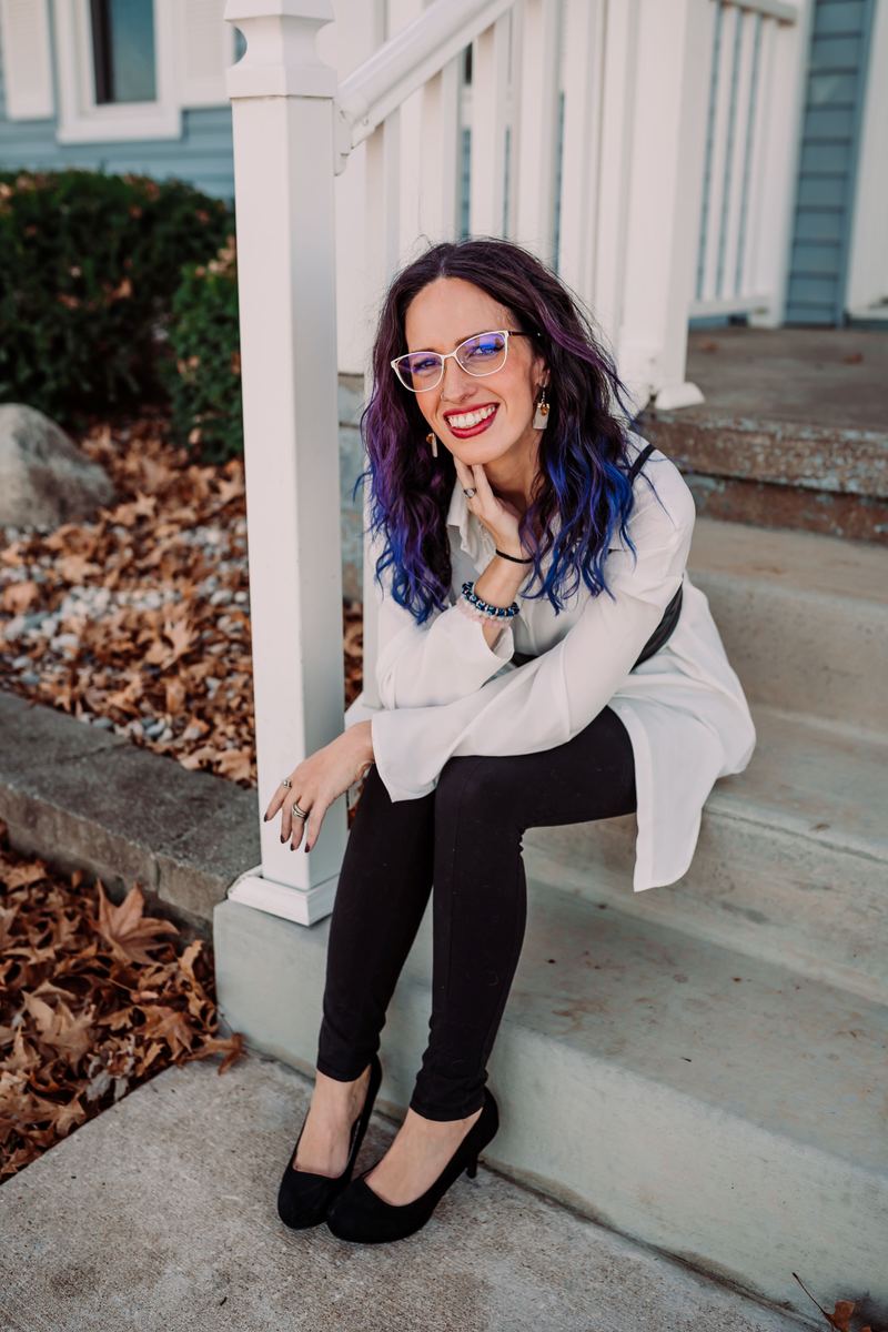 Angelita smiling on the front steps of a house